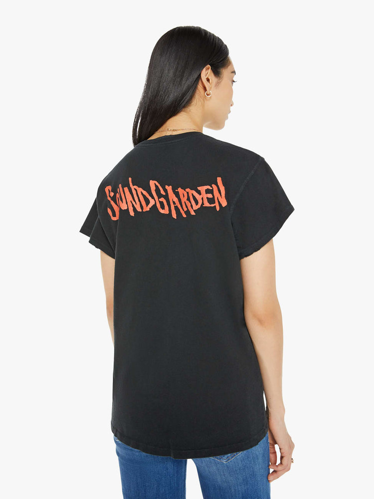 Back view of a woman distressed crewneck tee in black, the tee pays homage to Soundgarden's 1988 tour with a faded text graphic on the front and the band's logo on the back.