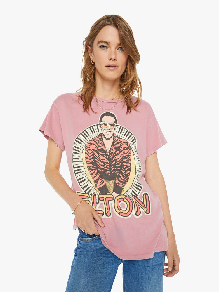 Front view of a woman  tee  that pays homage to the British musician, Elton John, with bold text and a graphic portrait on the front.