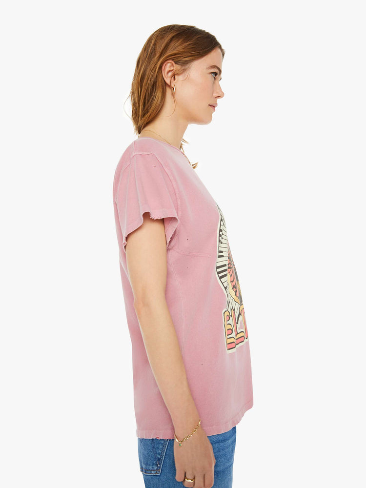 Side view of a woman tee that pays homage to the British musician, Elton John, with bold text and a graphic portrait on the front.