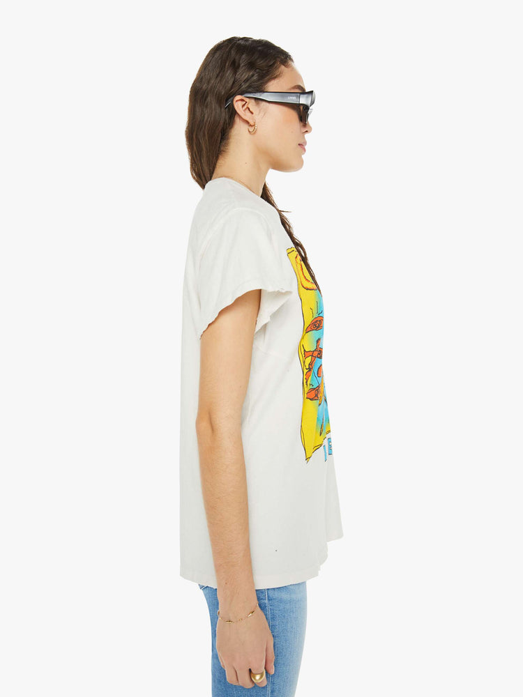 Side view women in a white tee pays homage to the The Cure with a colorful text graphic on the front.