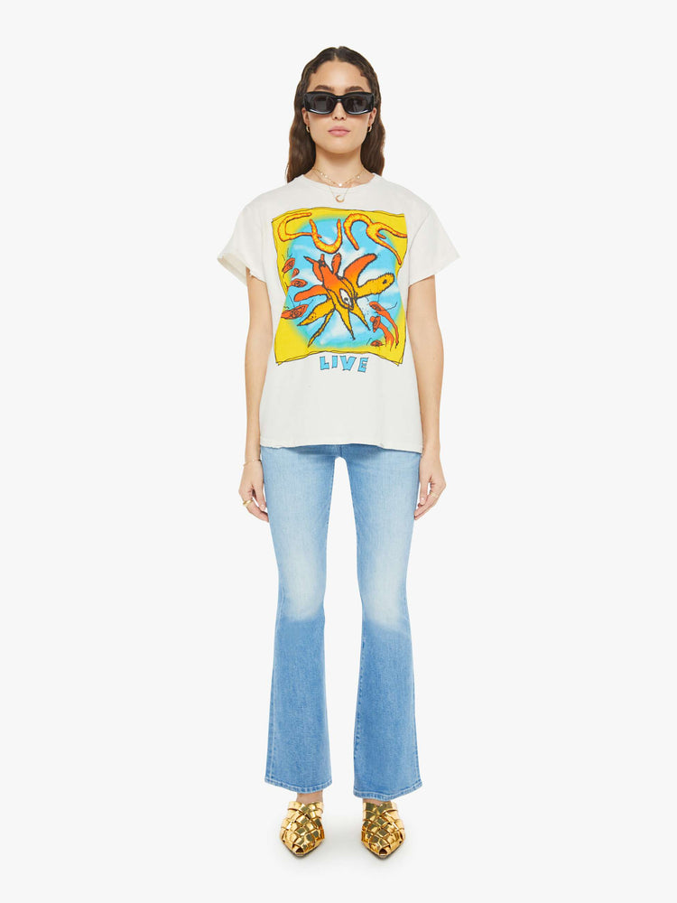 Full body view women in a white tee pays homage to the The Cure with a colorful text graphic on the front.