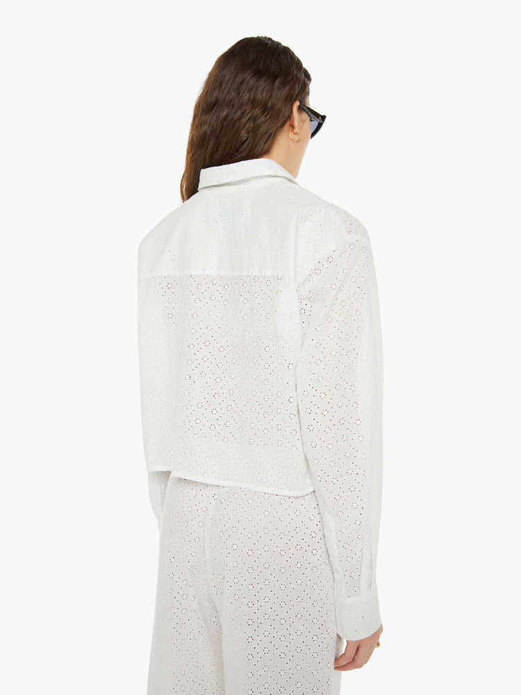 Back view of a woman white button up blouse with drop shoulders and a cropped, boxy fit.