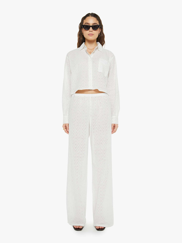 Full body view of a woman white button up blouse with drop shoulders and a cropped, boxy fit.