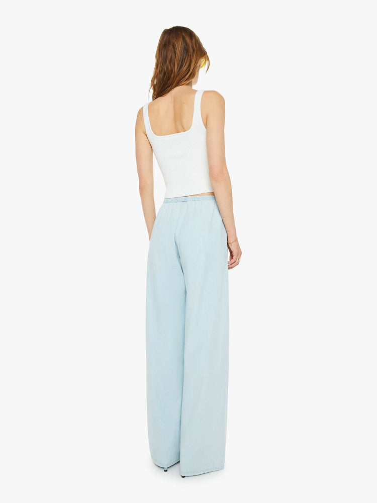 Back view of a woman sky blue pants with an elastic waistband and a comfortable fit.