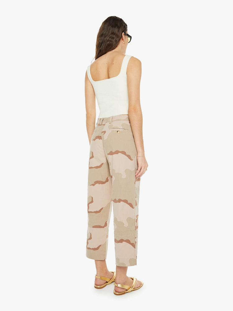 Back view of a woman in high rise, wide leg and ankle length inseam in khaki camouflage print, the trousers have a loose, comfortable fit.