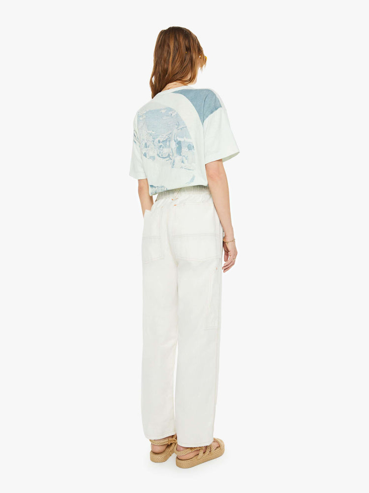 Backview of a woman pants have a mid rise, straight leg, drawstring waist with a woven belt and a loose fit.