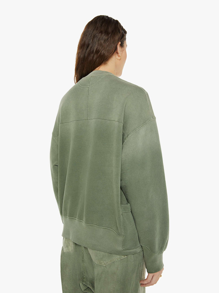 Back view of a woman in a sweatshirt that features drop shoulders, long, oversized sleeves, ribbed hems and a loose fit. It's made from 100% cotton French terry in olive green.