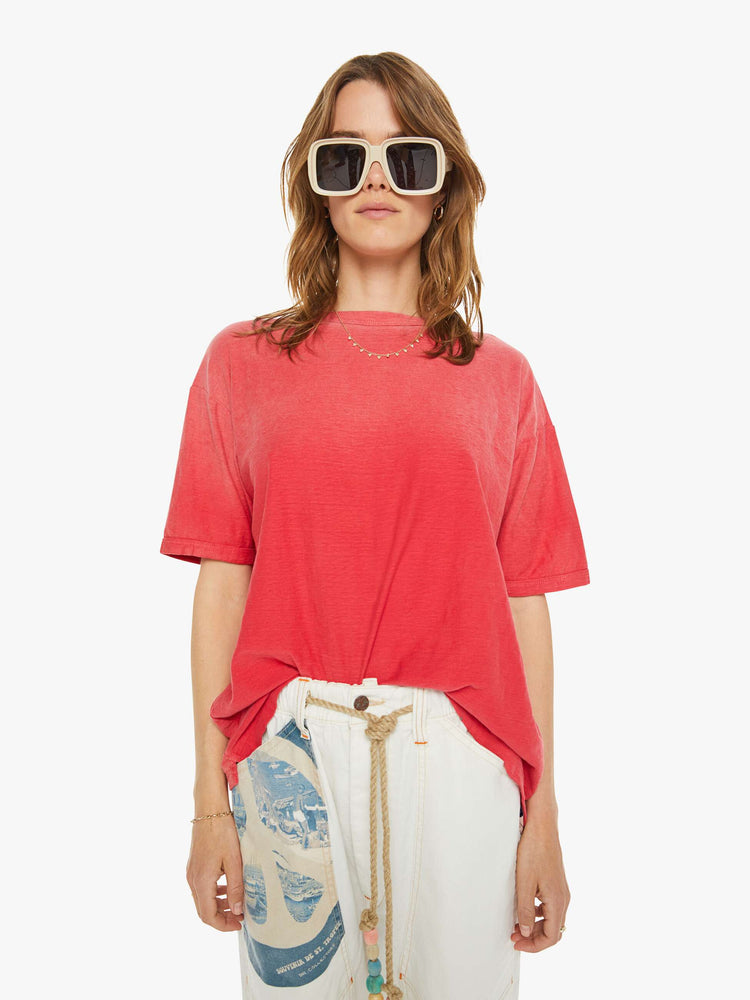 Front view of a woman in drop shoulders, short sleeves and a boxy fit tee in a faded red.