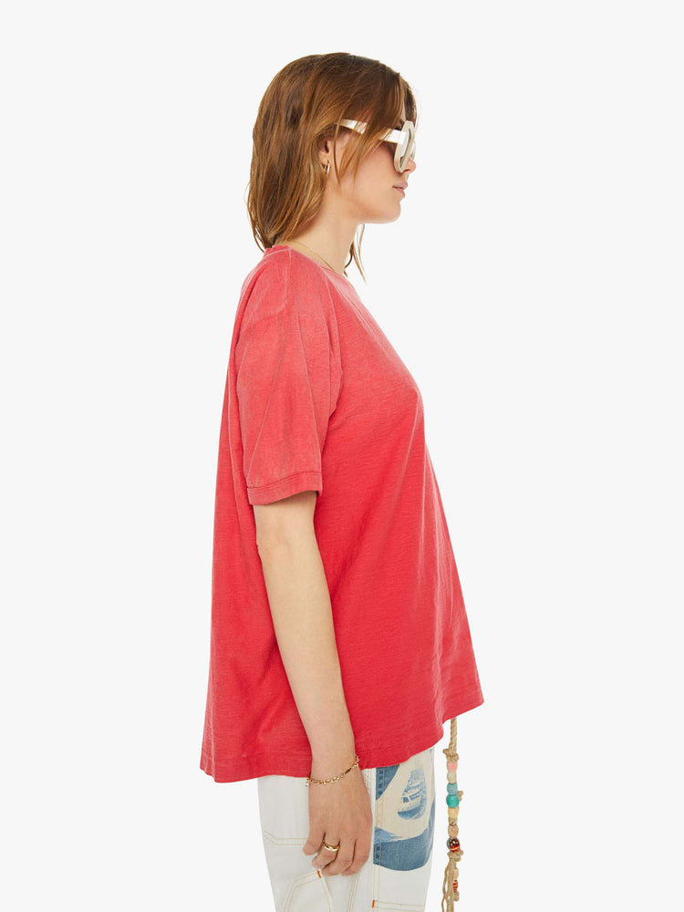 Side view of a woman in drop shoulders, short sleeves and a boxy fit tee in a faded red.