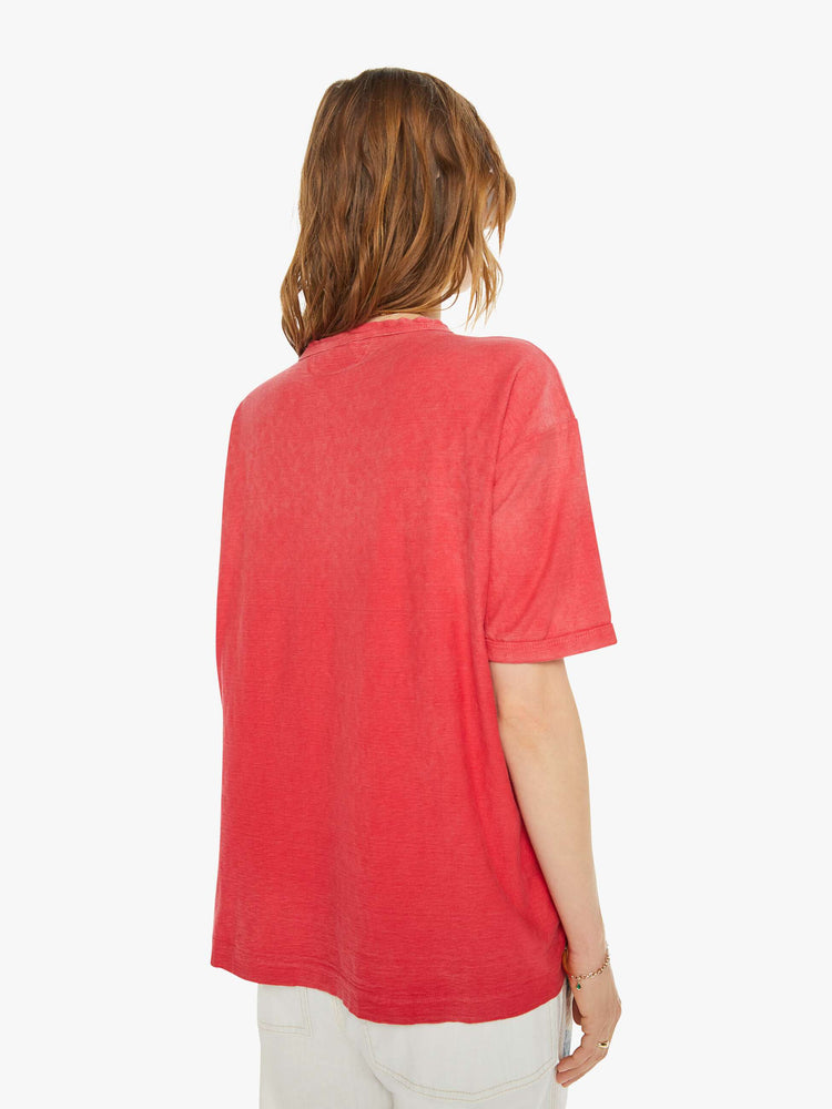 Back view of a woman in drop shoulders, short sleeves and a boxy fit tee in a faded red.