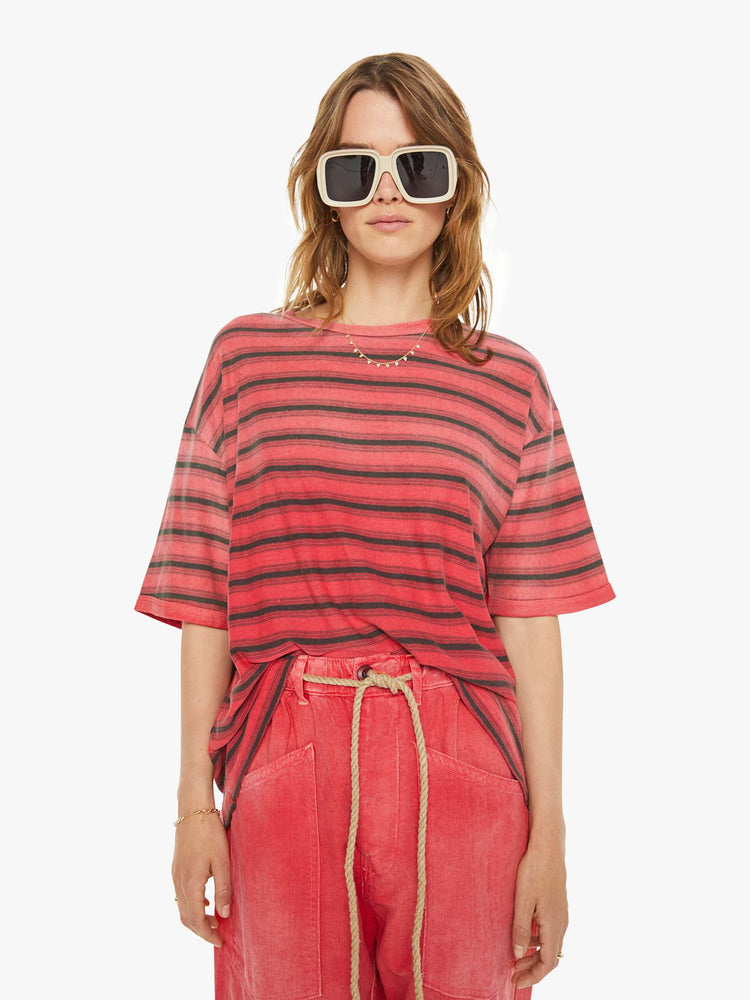 Front view of a woman  drop shoulders, short sleeves and a boxy fit in red with navy stripes.
