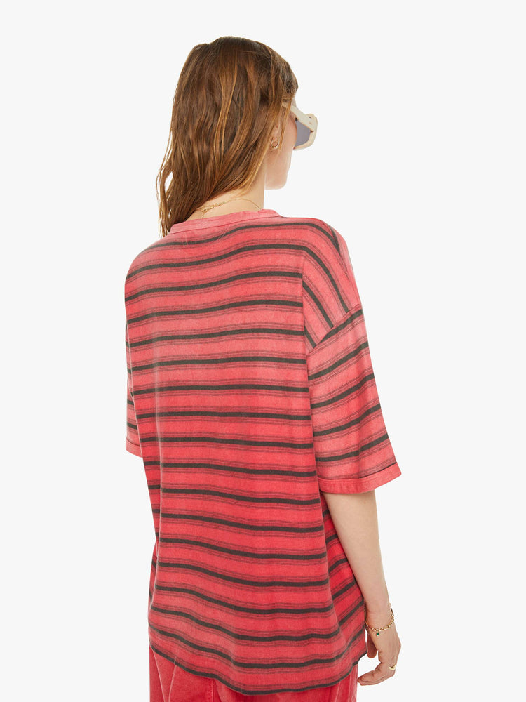 Back view of a woman drop shoulders, short sleeves and a boxy fit in red with navy stripes.