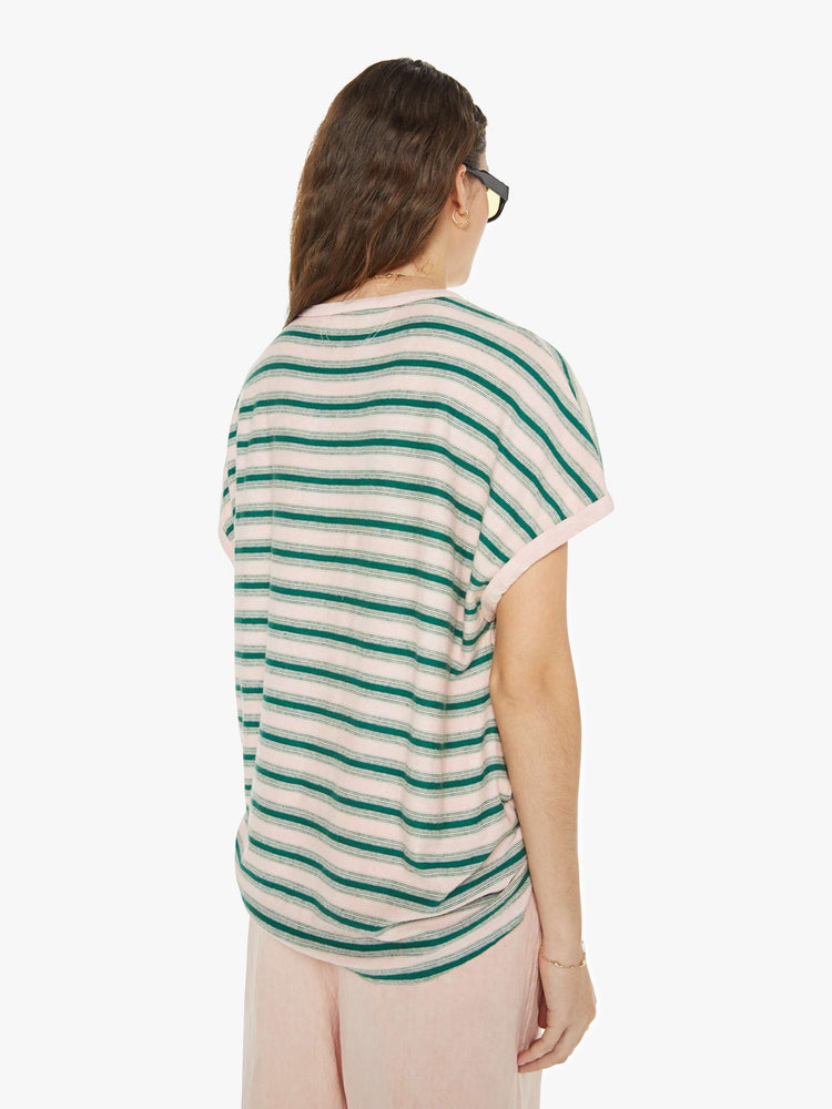 Back view of a woman in a short-sleeve crewneckwith slightly dropped shoulders and a loose, oversized fit in horizontal stripes in pink and green.