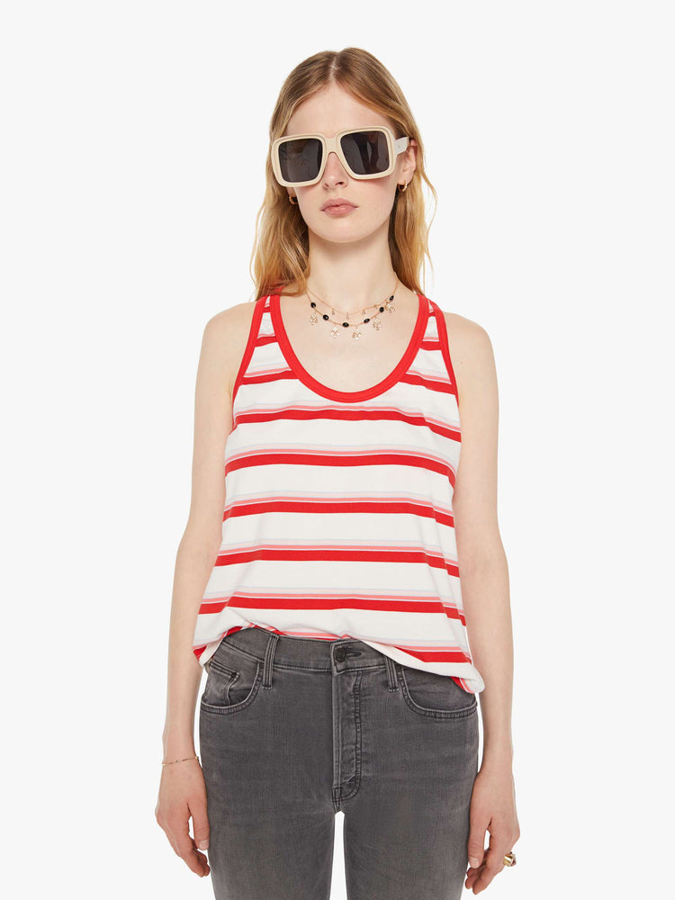 Front view of a woman in a white tank with red trim and stripes.