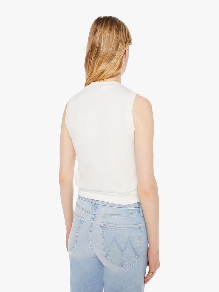 Back view of a woman in a white vest with a ribbed hem.