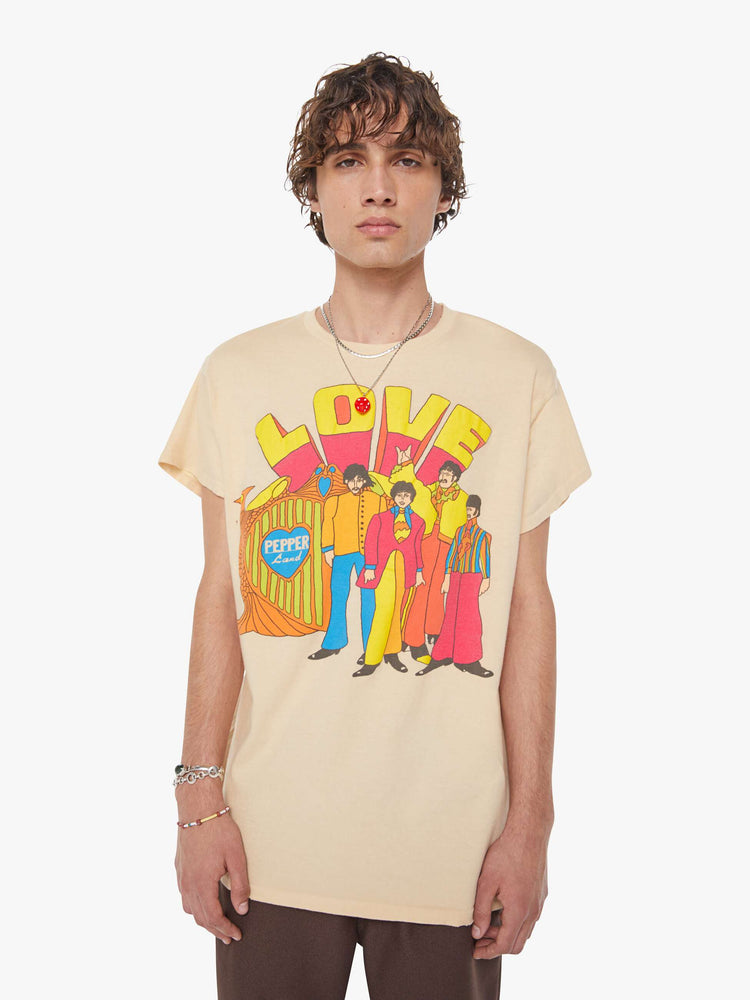 MEN front view in a tea-stained white tee that pays homage to The Beatles with a colorful graphic on the front.