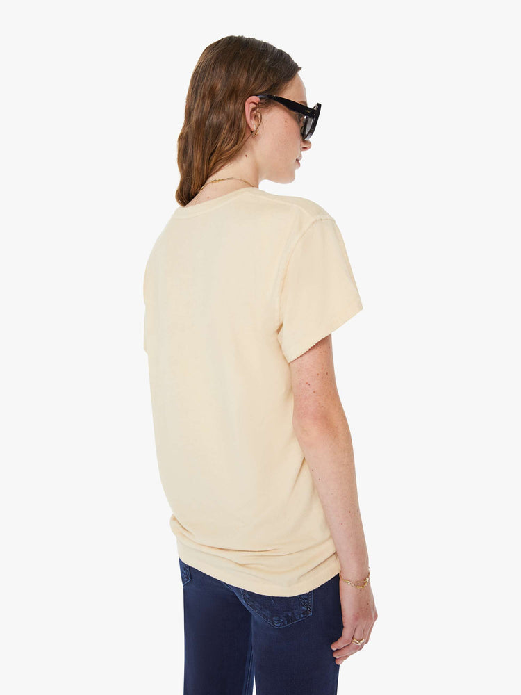 WOMEN back view in a tea-stained white tee that pays homage to The Beatles with a colorful graphic on the front.