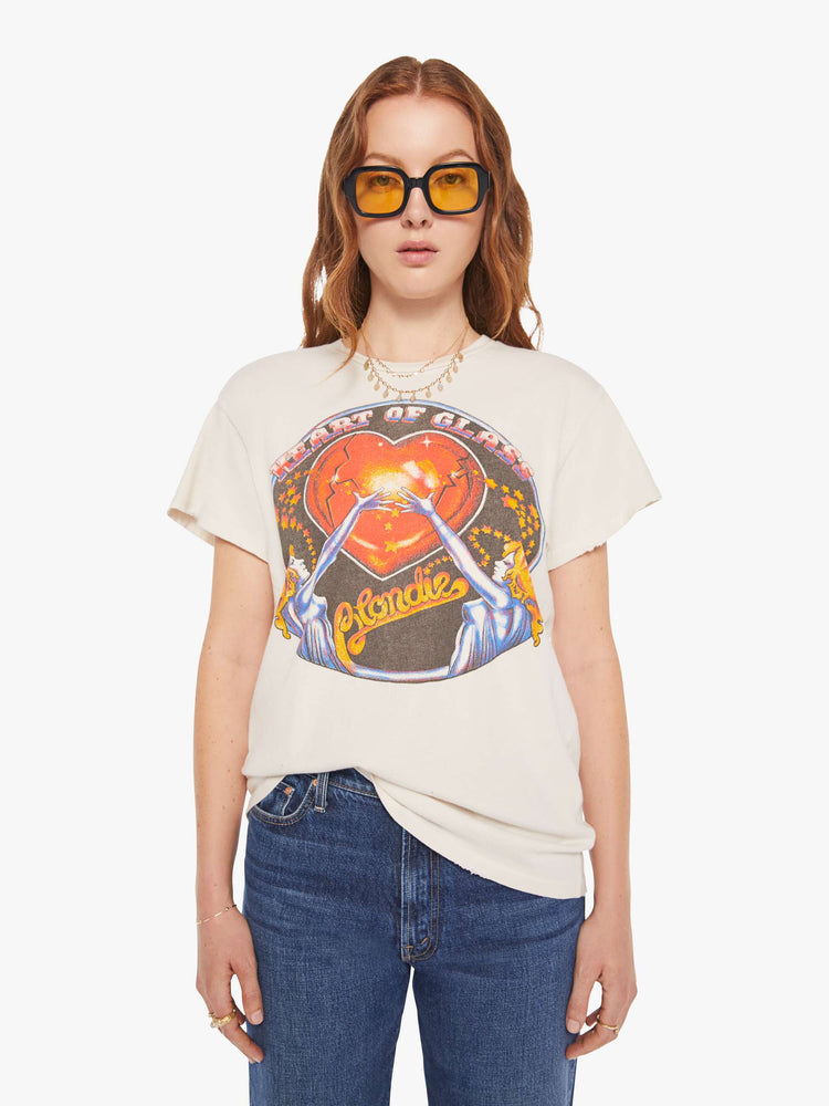 Front view of a woman in a white tee that  pays homage to Blondie with a graphic on the front.