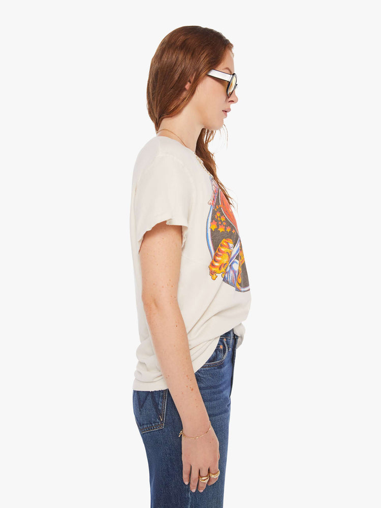 Side view of a woman in a white tee that  pays homage to Blondie with a graphic on the front.