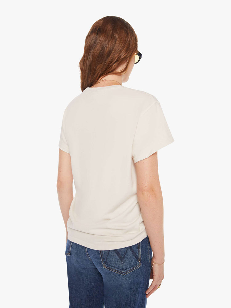 Back view of a woman in a white tee that  pays homage to Blondie with a graphic on the front.