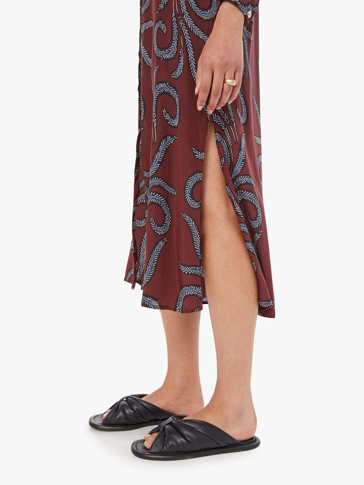 Swatch view of a woman in  a flowy dress is designed with a V-neck, buttons down the front, slightly cropped long sleeves and a loose, flowy fit.