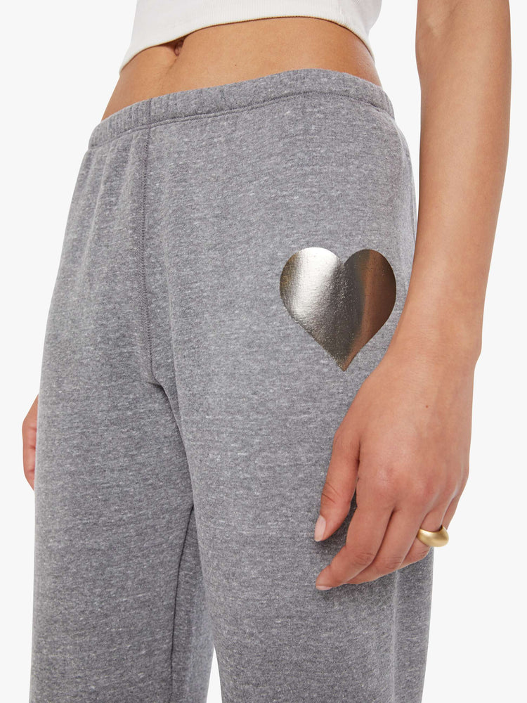 Close up view of a woman in a black heart on the hip grey sweatpants with an elastic waist and cuffs for a loose, comfortable fit. 