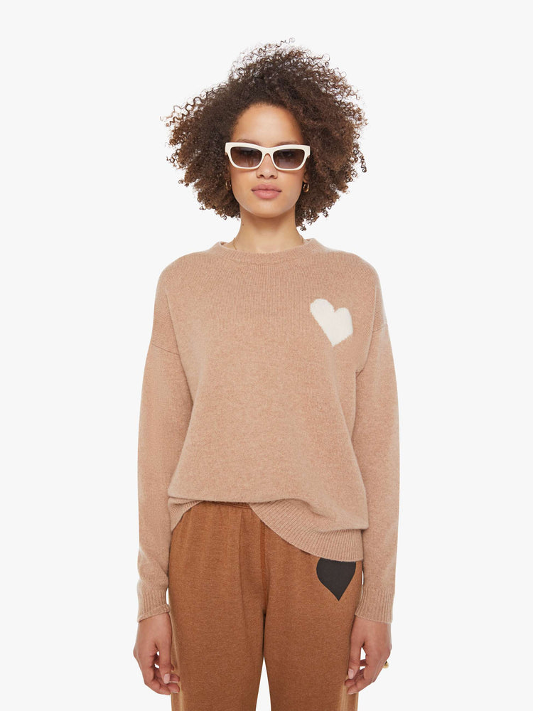 Front view of a woman in a light khaki sweater with a crewneck and drop shoulders.