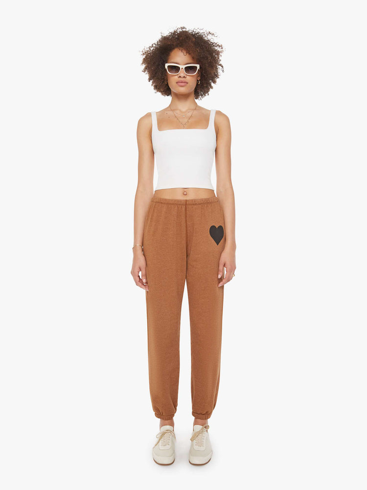 Front view of a woman in a khaki sweatpant with a black heart and an elastic waist and cuffs for a loose.