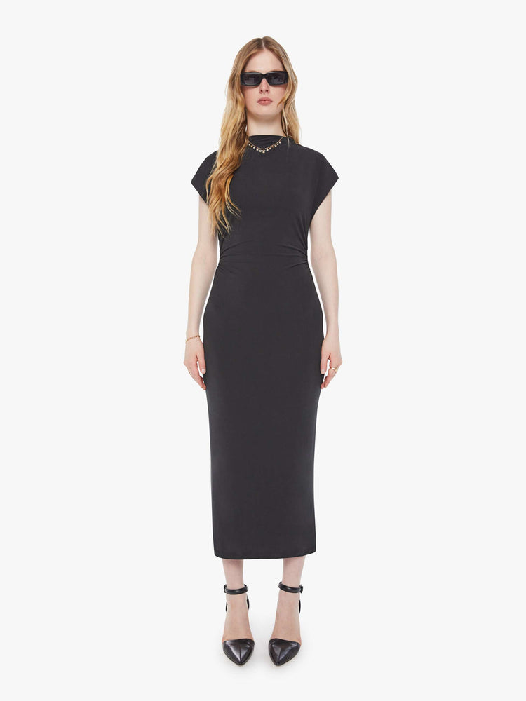 Front view of a woman in a black midi dress designed with a mock neck, short sleeves, a narrow fit and calf-grazing hem.