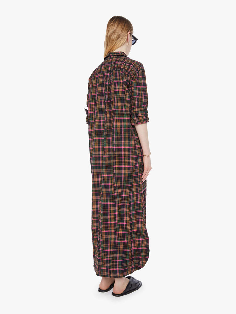 Back view of a woman in brown plaid dress has a collared neckline, elbow-length sleeves, buttons down the front and a loose, boxy fit.