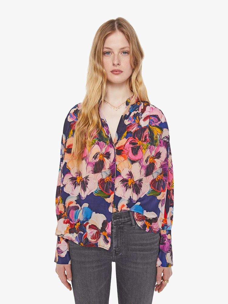 Front view of a woman in oversized floral print top with a V-neck, dropped shoulders and a slightly cropped fit.