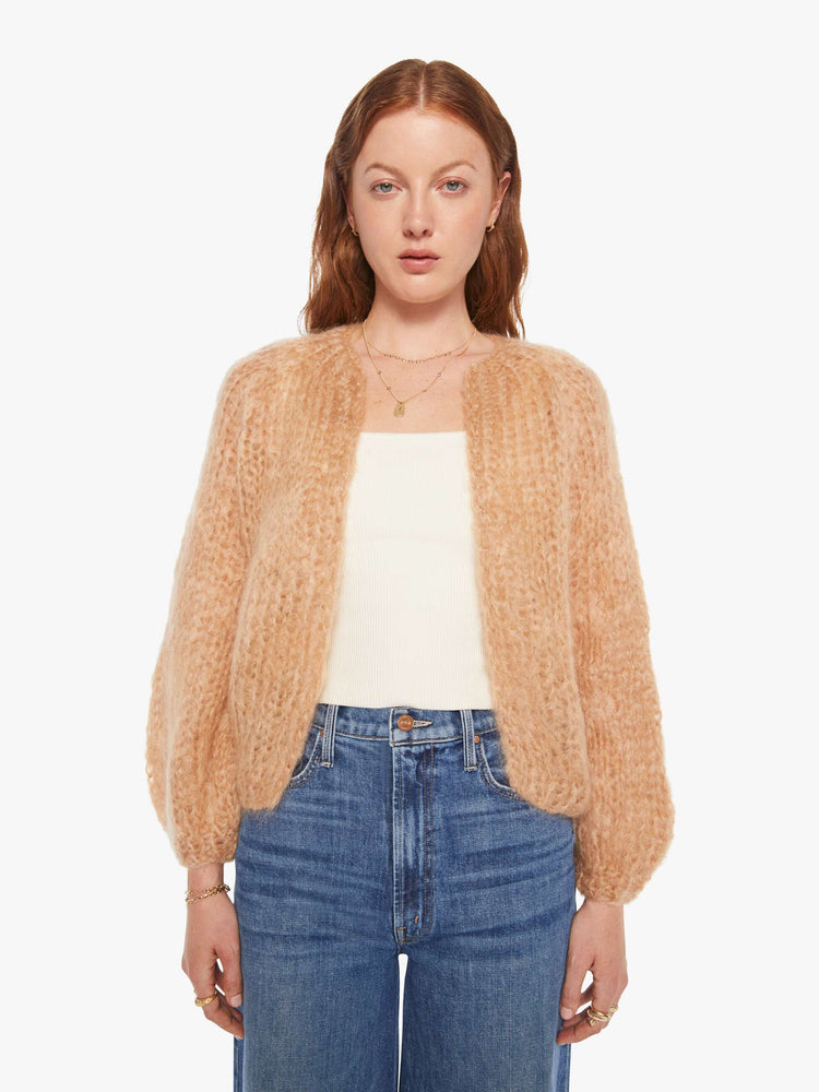 Front view of a woman in a camel cardigan.