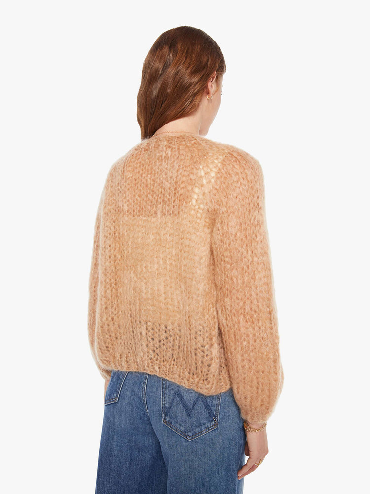 Back view of a woman in a camel cardigan.