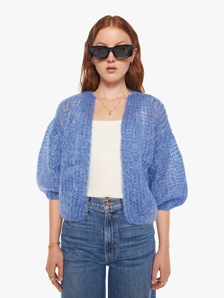 Front view of a woman in a baby blue bomber jacket inspired cardigan.