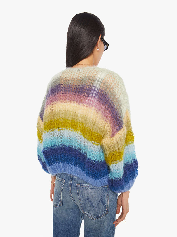 Back  view of a woman in  ribbed cardigan is hand knit from a soft blend of mohair and wool in a multicolor horizontal stripe pattern
