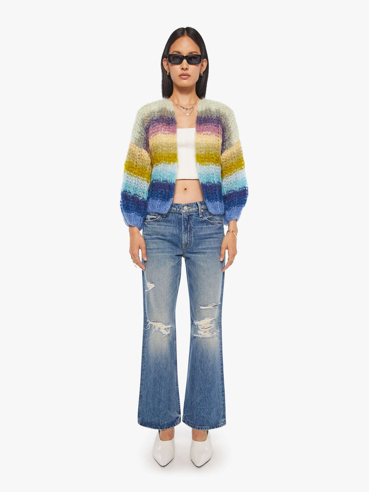 Full body  view of a woman in  ribbed cardigan is hand knit from a soft blend of mohair and wool in a multicolor horizontal stripe pattern