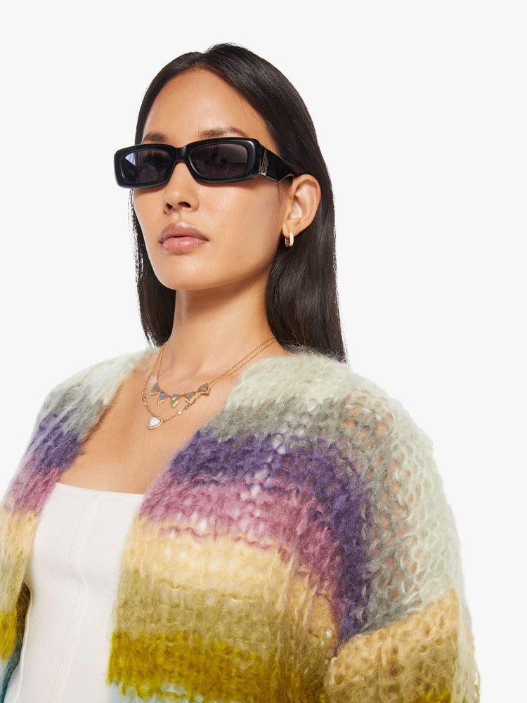 Close up  view of a woman in  ribbed cardigan is hand knit from a soft blend of mohair and wool in a multicolor horizontal stripe pattern