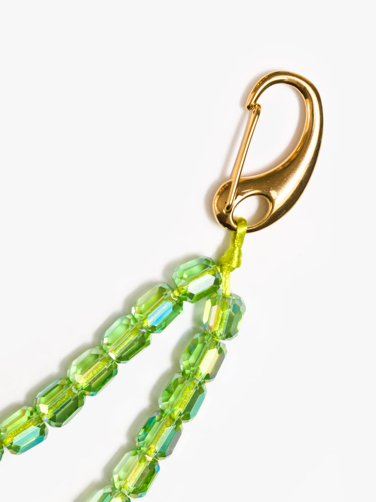 Clasp view of a green keychain with a combination of glass, bone, acrylic and gold-plated beads.
