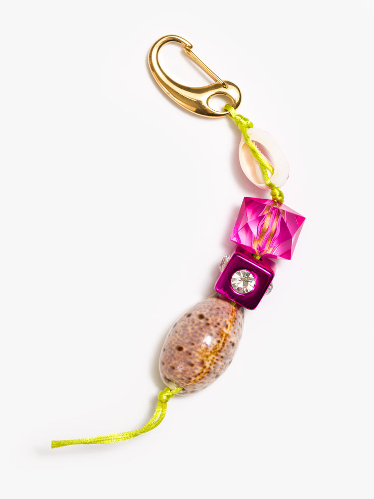 Flat view of a keychain with pink acrylic and rhinestone beads, a painted cowrie shell and a large cowrie at the bottom.