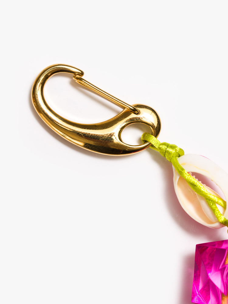 Clasp view of a keychain with pink acrylic and rhinestone beads, a painted cowrie shell and a large cowrie at the bottom.