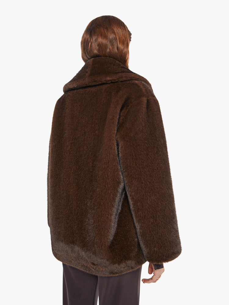 Back view of a woman in an oversized blazer in brown faux fur.