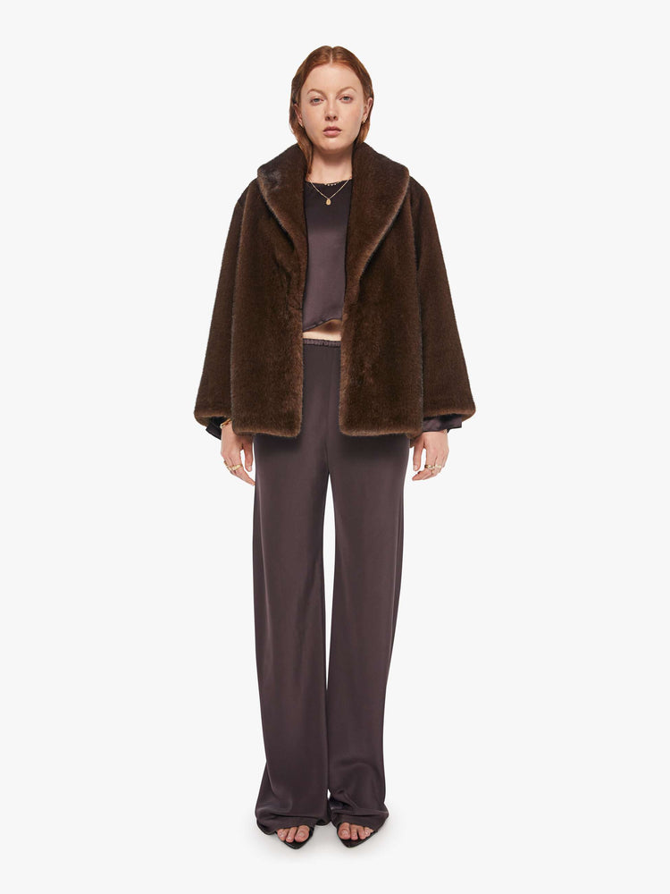 Full body view of a woman in an oversized blazer in brown faux fur.