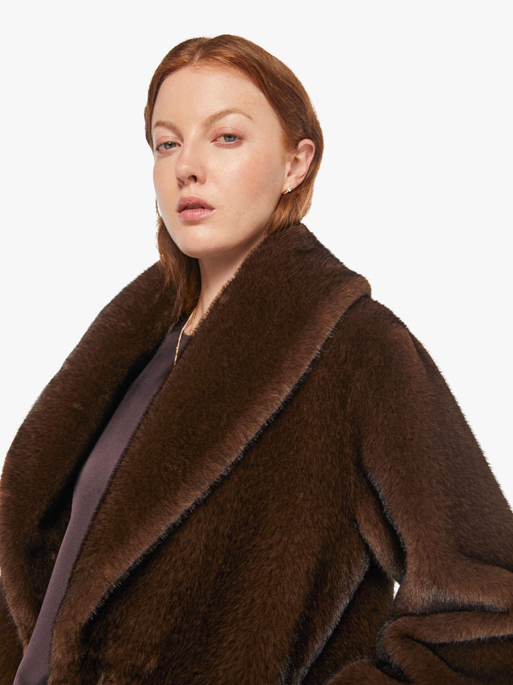 Close up view of a woman in an oversized blazer in brown faux fur.