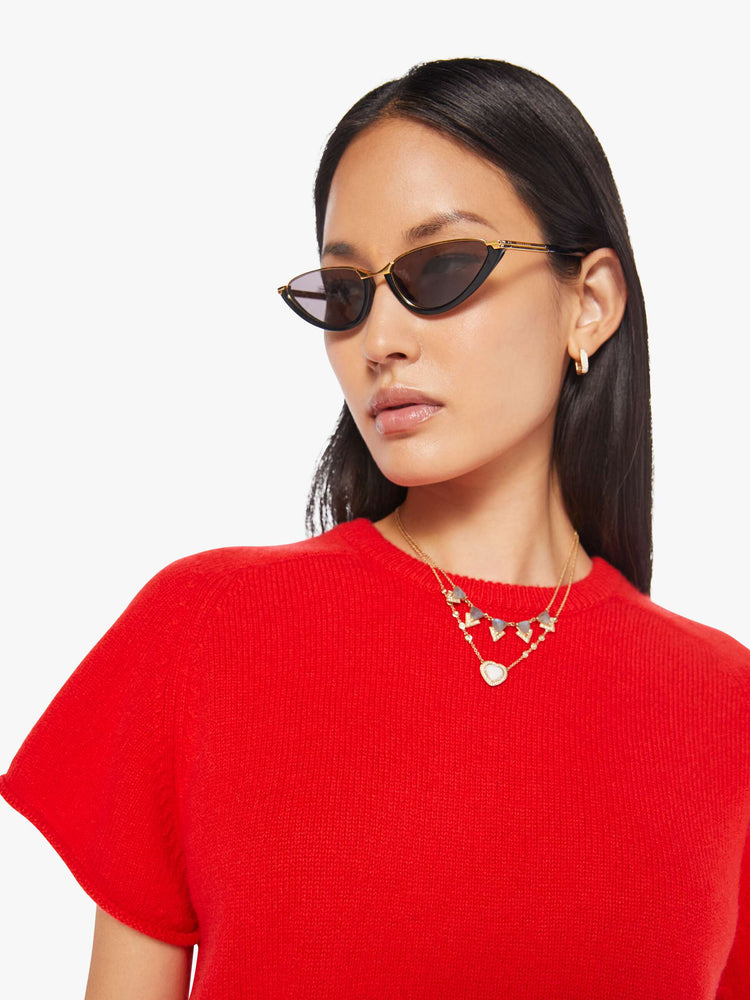 Close up view of a woman in  bright red, the short-sleeve sweater is designed with a crewneck, ribbed hem and a slightly cropped fit.