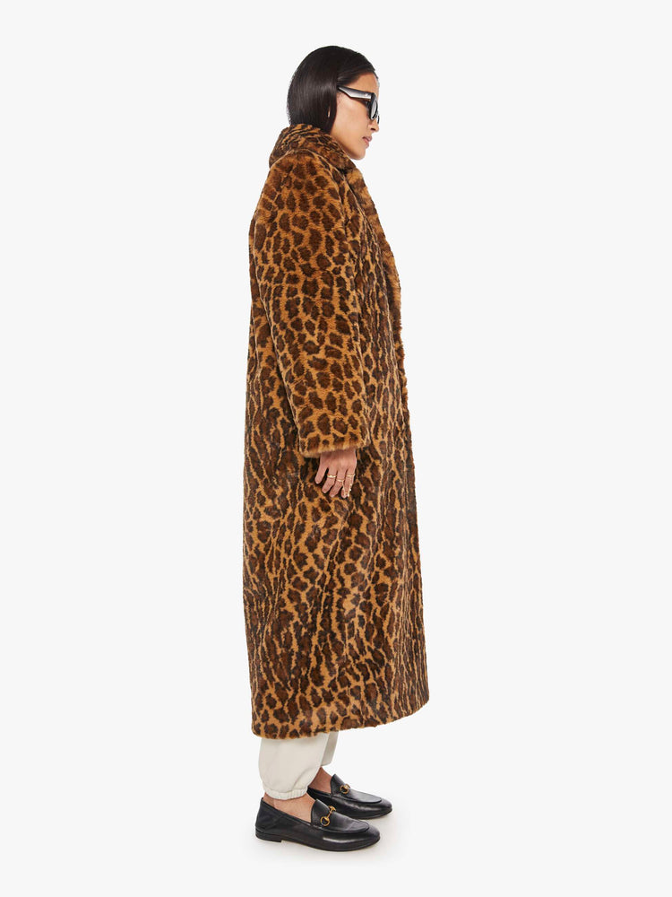 Side view of a woman in a coat with in leopard print.