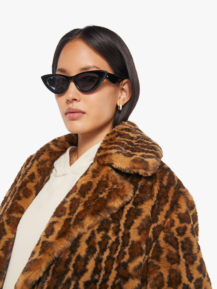 Close up view of a woman in a coat with in leopard print.