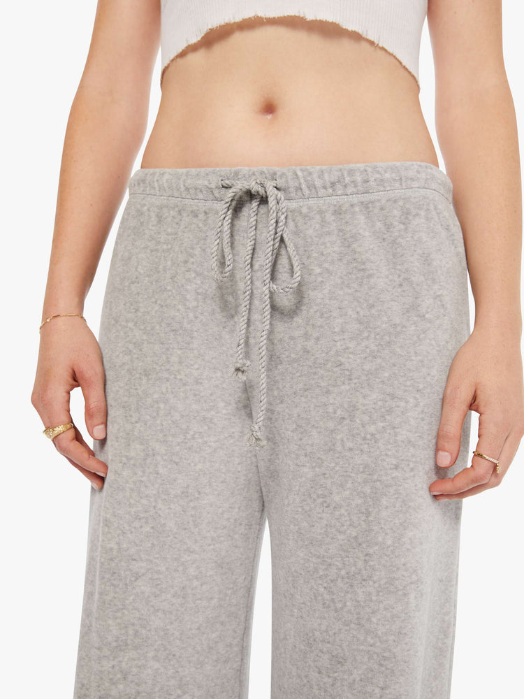 Full body view woman in a heather grey wide-leg sweatpants.