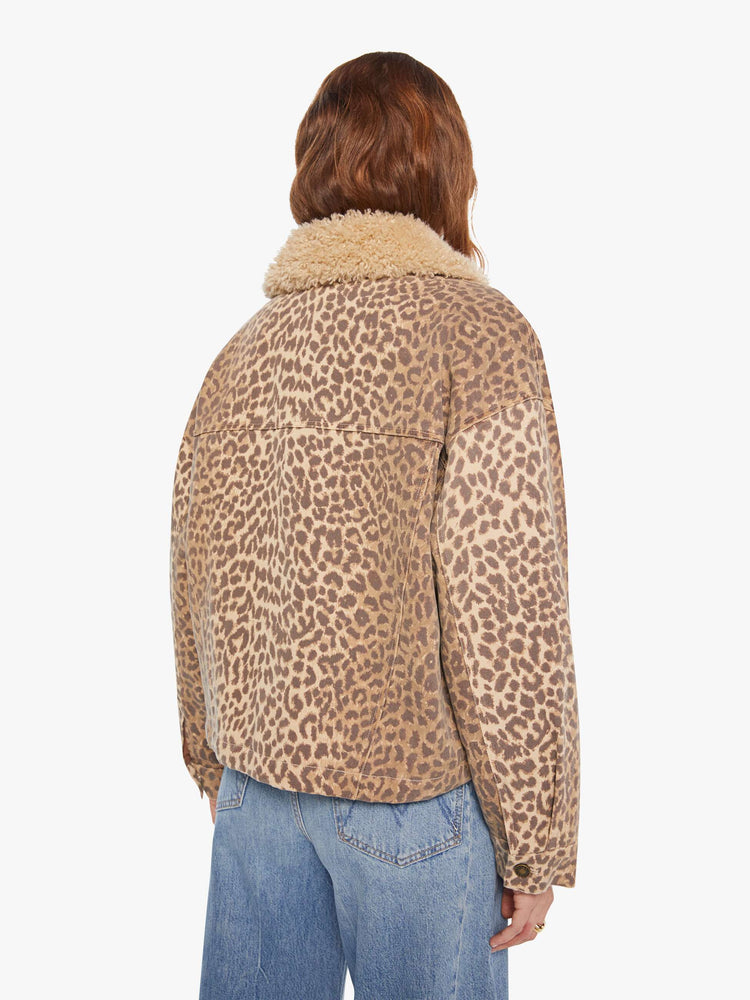Back  view of a woman in a cheetah print jacker with a faux-shearling collar, patch pockets, buttons down the front and a boxy, oversized fit.