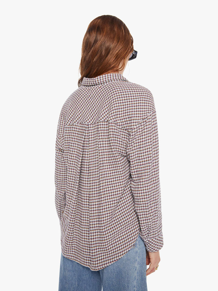 Back view of a woman in a white and baby blue checker print long sleeve shirt is designed with drop shoulders, a front patch pocket, curved hem and slightly cropped fit.