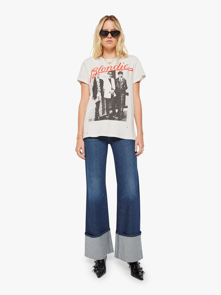 Full body view of a woman in a white tee pays homage to Blondie with a black-and-white photograph and the band's name in red on the front.